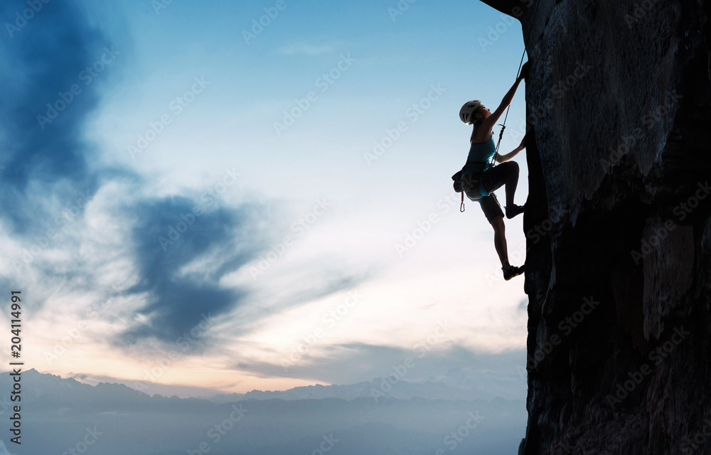 Young woman on the cliff rock climbing Young woman on the cliff rock climbing