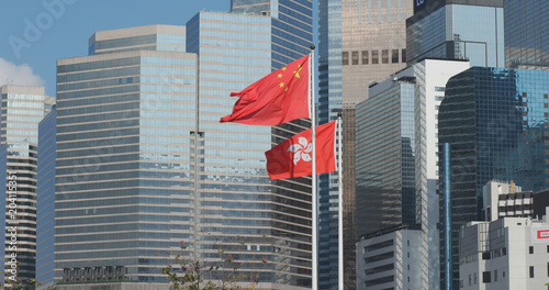 Hong Kong business office tower with Hong Kong and China flag