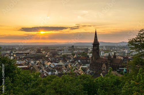 Germany, Romantic sunset light over roofs of city Freiburg im Breisgau