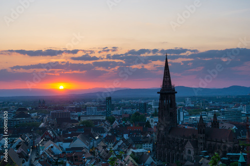 Germany, Red sunset behind vosges mountains over city Freiburg im Breisgau