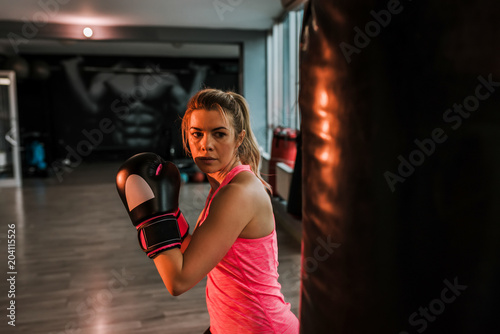 Good-looking woman concentrating on boxing. © bnenin