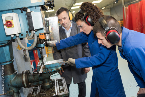 Students using bench drill