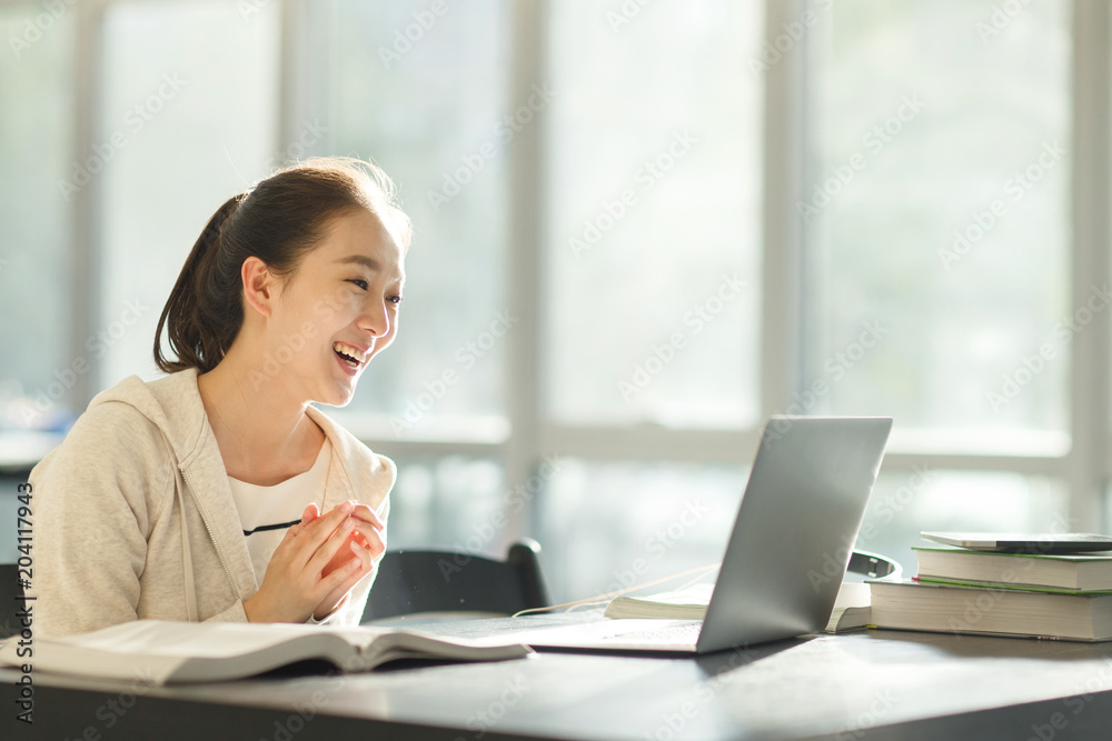 Young college student using laptop for video call Young college student using laptop for video call