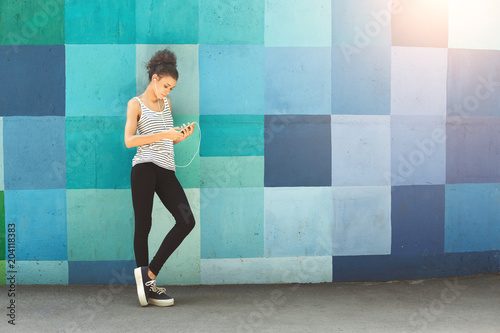 African-american woman posing at bright wall photo