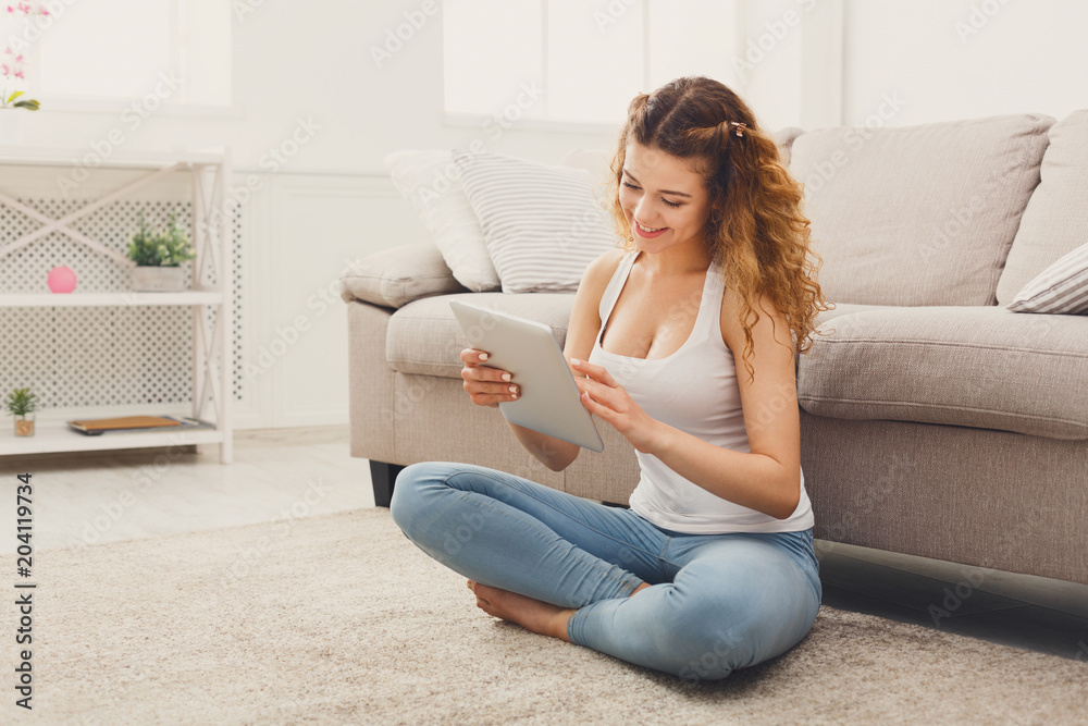 Young girl using digital tablet at home Young girl using digital tablet at home