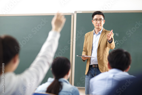 Teacher teaching students in a classroom photo