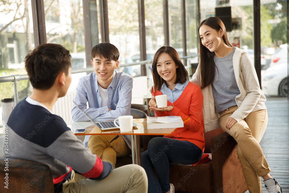 Young men and women in the coffee shop Young men and women in the coffee shop