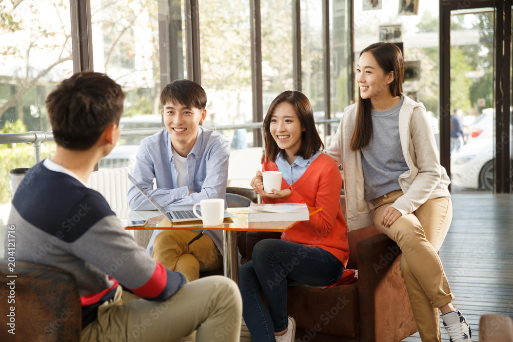 Young men and women in the coffee shop Young men and women in the coffee shop