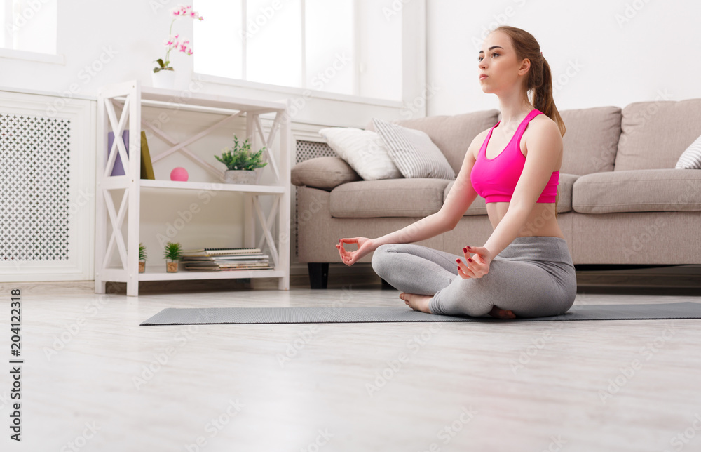 Woman training yoga in lotus pose Woman training yoga in lotus pose