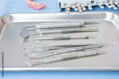 Close up dentist tools on metal tray in dental clinic, preparation before operating.