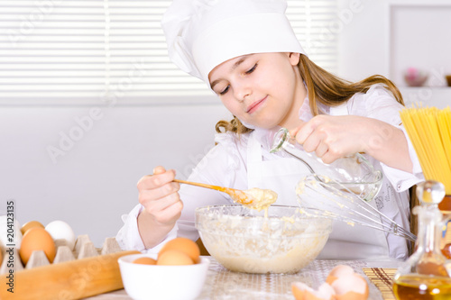 Cute girl cooking  in the kitchen