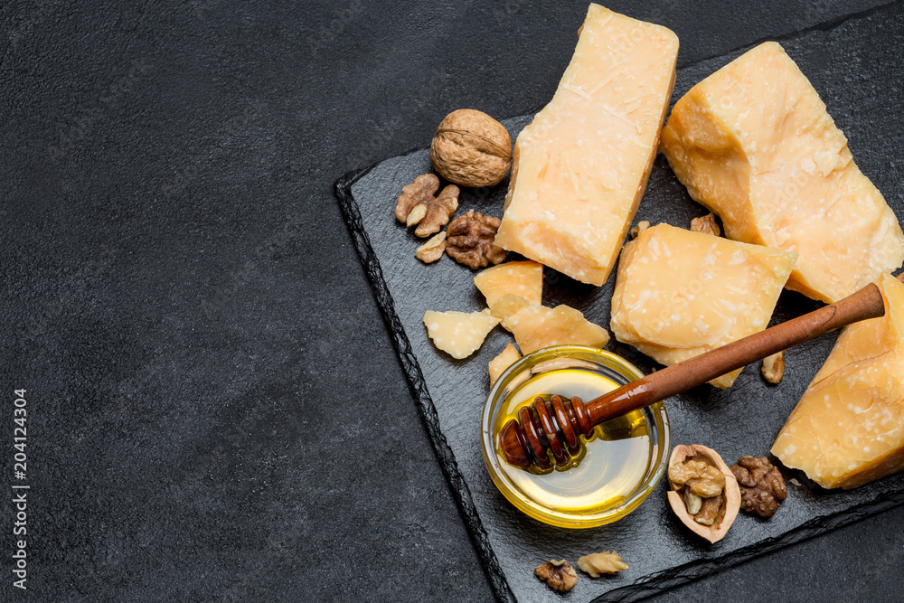 pieces of parmesan or parmigiano cheese and honey