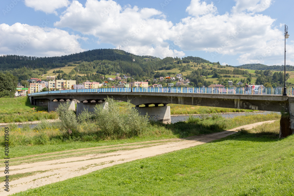 Fototapeta premium Bridge over Poprad River in Muszyna Zdroj in Poland