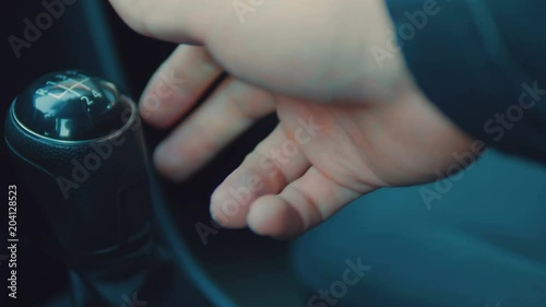 Male hand on the shift lever of the transmission in the car. photo