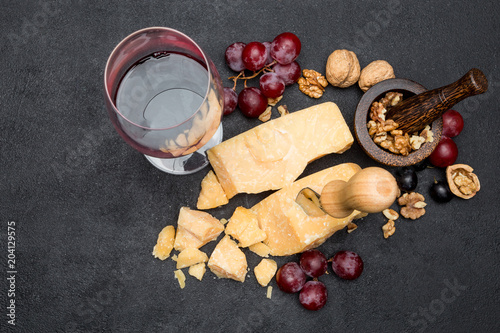 pieces of parmesan or parmigiano cheese, wine and grapes