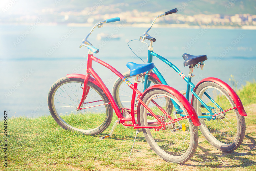 Fototapeta premium Two bright bicycles on the background of the sea