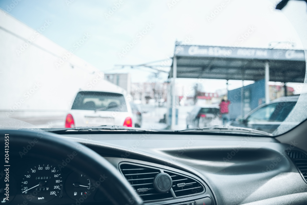 Fototapeta premium car line in car wash. time to clean auto. view from inside