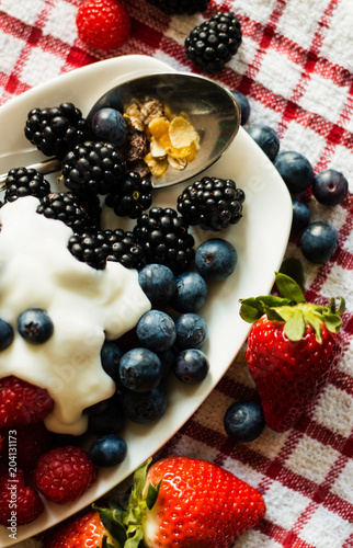 Macro view of blackberries, blueberries, raspberries and muesli