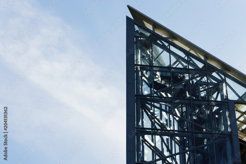 The glass elevator shaft with metal partitions on the street adjoins the bridge. The glass elevator shaft with metal partitions on the street adjoins the bridge.