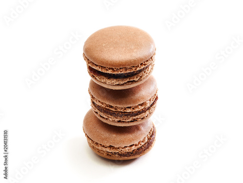 Fresh baked brown Macarons, or macaroons isolated on white background