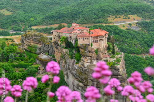 Meteora Monastry with pink flowers in Kalambaka, Greece photo