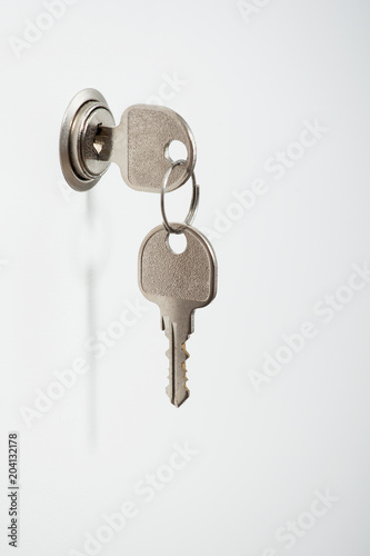 key in the keyhole on the white door