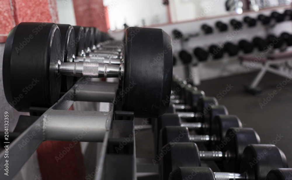 Fototapeta premium Dumbbell weights on rack in gym