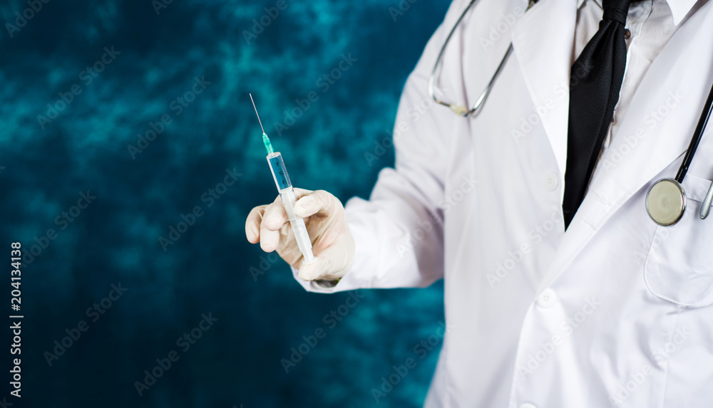 Doctor holding a syringe close up Doctor holding a syringe close up