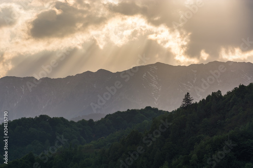 Mountains, Forest, Clouds and Beautiful Sun Rays