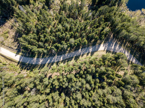 drone image. aerial view of rural area with fields and forests and gravel roads seen from above