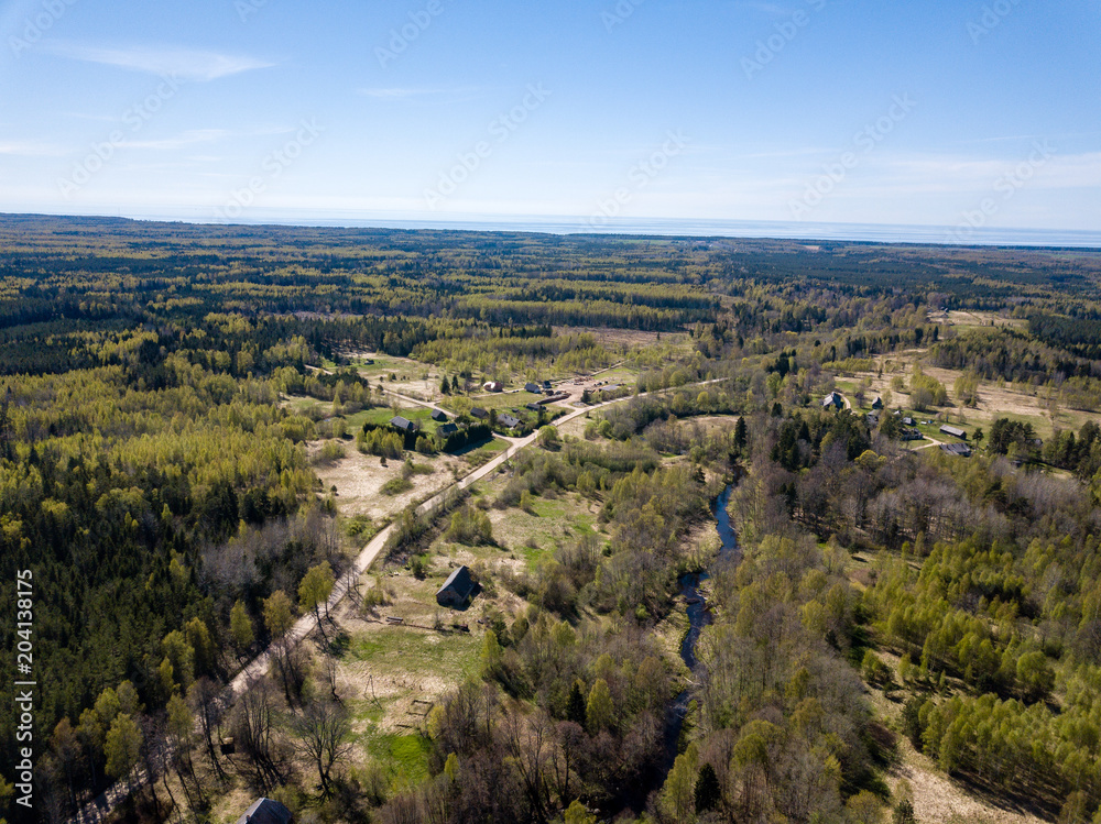 drone image. aerial view of rural area with river in forest from above