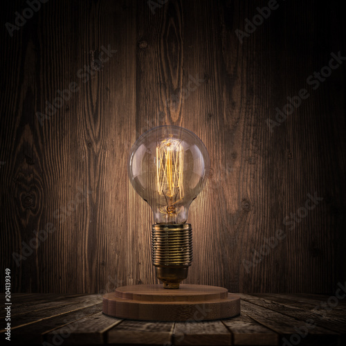 Valokuva Vintage light bulb on dark background.