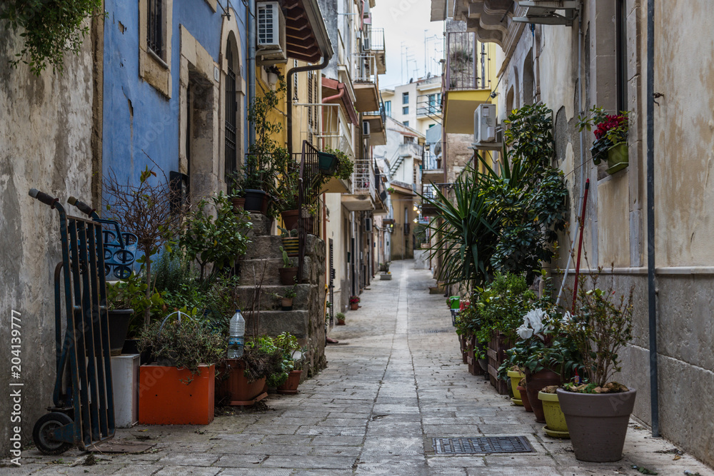 Street of the old town with houses of the historic village of Ragusa in Sicily, Italy