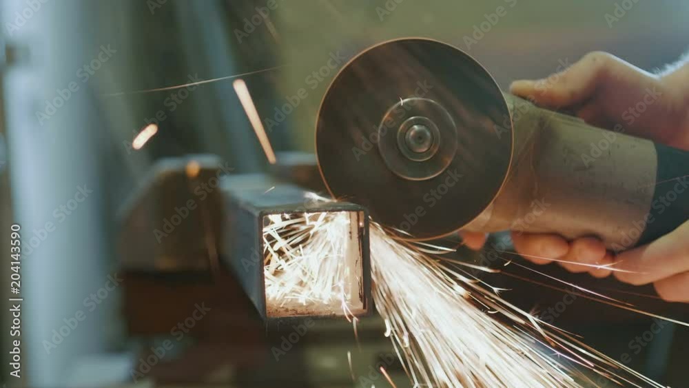 worker cutting metal with a power tool