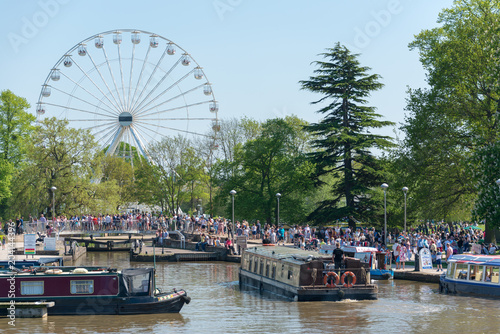 Major crowd gathering around ferris wheel and canal boats for river festival in England  photo