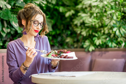 Woman with healthy food at the restaurant