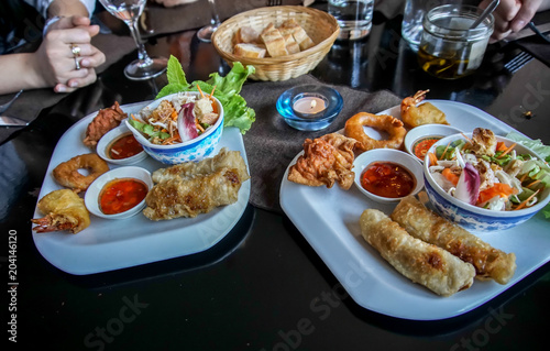 delicious mixed dish of fried spring roll, prawn fritters, deep fried squid cuttlefish and fried wonton, asian cooking and recipe