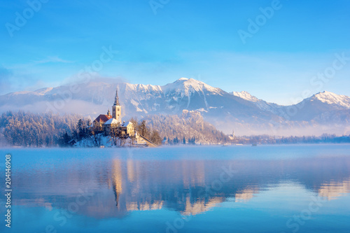 Lake bled on a winter sunny morning with clear sky and snow covering the mountains