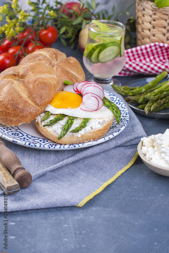 Fresh bread for breakfast, with egg, salad, asparagus, salmon, radish. Healthy food and drink. Place for text. Fresh bread for breakfast, with egg, salad, asparagus, salmon, radish. Healthy food and drink. Place for text.