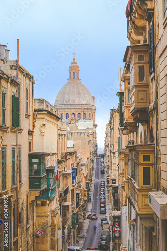 Dome of churche of Our Lady of Mount Carmel and narrow street of Valletta, Capital city of Malta