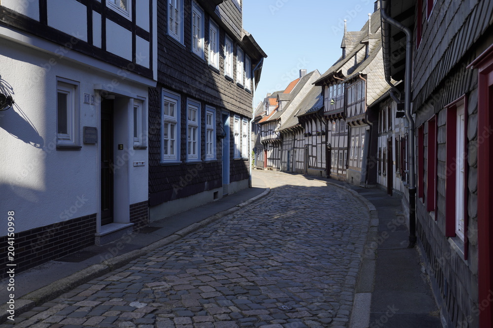 Fototapeta premium Tiny street with old nordic style houses in the town of Goslar, Germany in the Harz region.