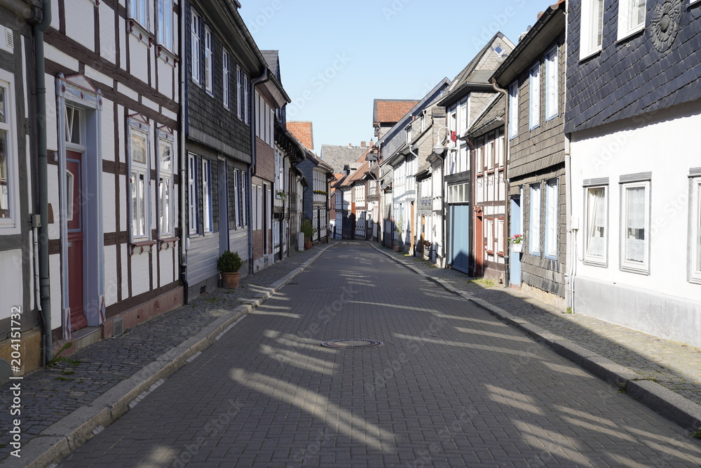 Tiny street with old nordic style houses in the town of Goslar, Germany in the Harz region.