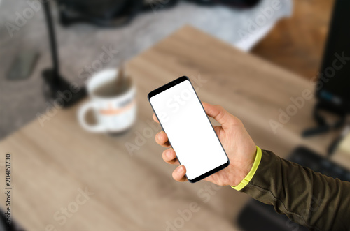 Man holding modern smartphone with isolated white screen for mock up presentation