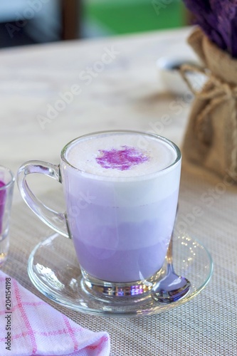 Hot macchiato of purple potato on the table