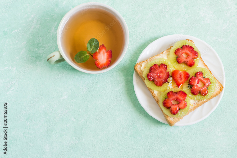 Toast with cream cheese, kiwi and strawberries in form of flowers Toast with cream cheese, kiwi and strawberries in form of flowers