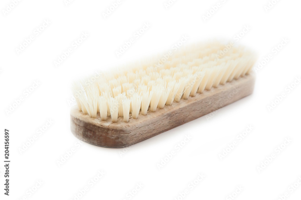 Old clothes brush with bristles and a wooden light body on white background. Old clothes brush with bristles and a wooden light body on white background.