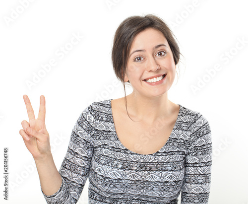 Smiling young woman showing victory or peace photo