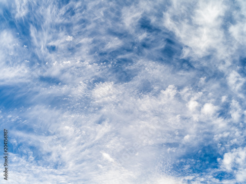 Wispy cloudscape against a blue sky.