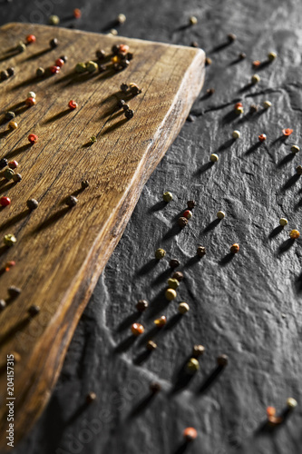 Colour pepper on wooden desk and black table background