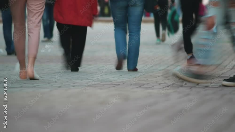 People crossing street time-lapse, close up of feet. people moving in crowded city street. Art toning abstract urban background. large group of young men and women walking. The urban landscape People crossing street time-lapse, close up of feet. people moving in crowded city street. Art toning abstract urban background. large group of young men and women walking. The urban landscape